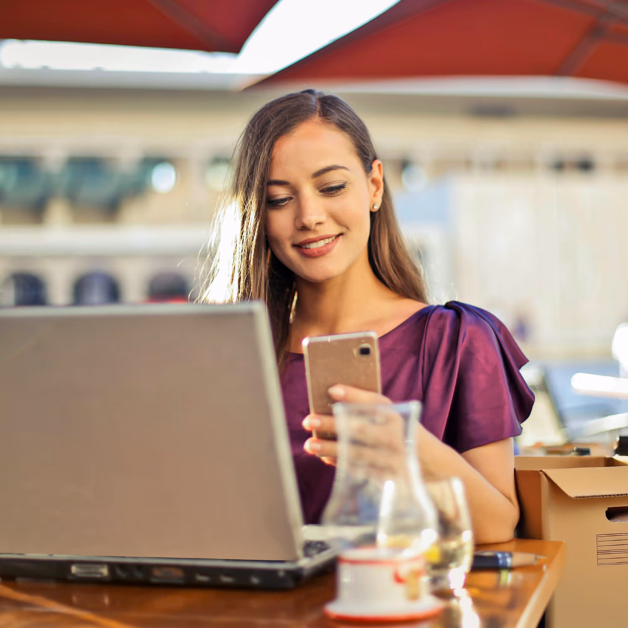 Shopify merchant working between laptop and mobile device